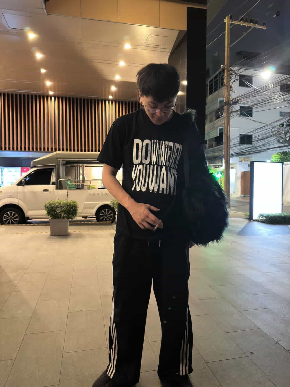 Duvachon MY BOYFRIEND DOES NOT PAY TAXES tee worn descending stairs at a festival